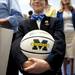 Dexter resident Connor Meadows, 11, holds basketball to be signed by players before the basketball banquet on Tuesday, April 16. AnnArbor.com I Daniel Brenner